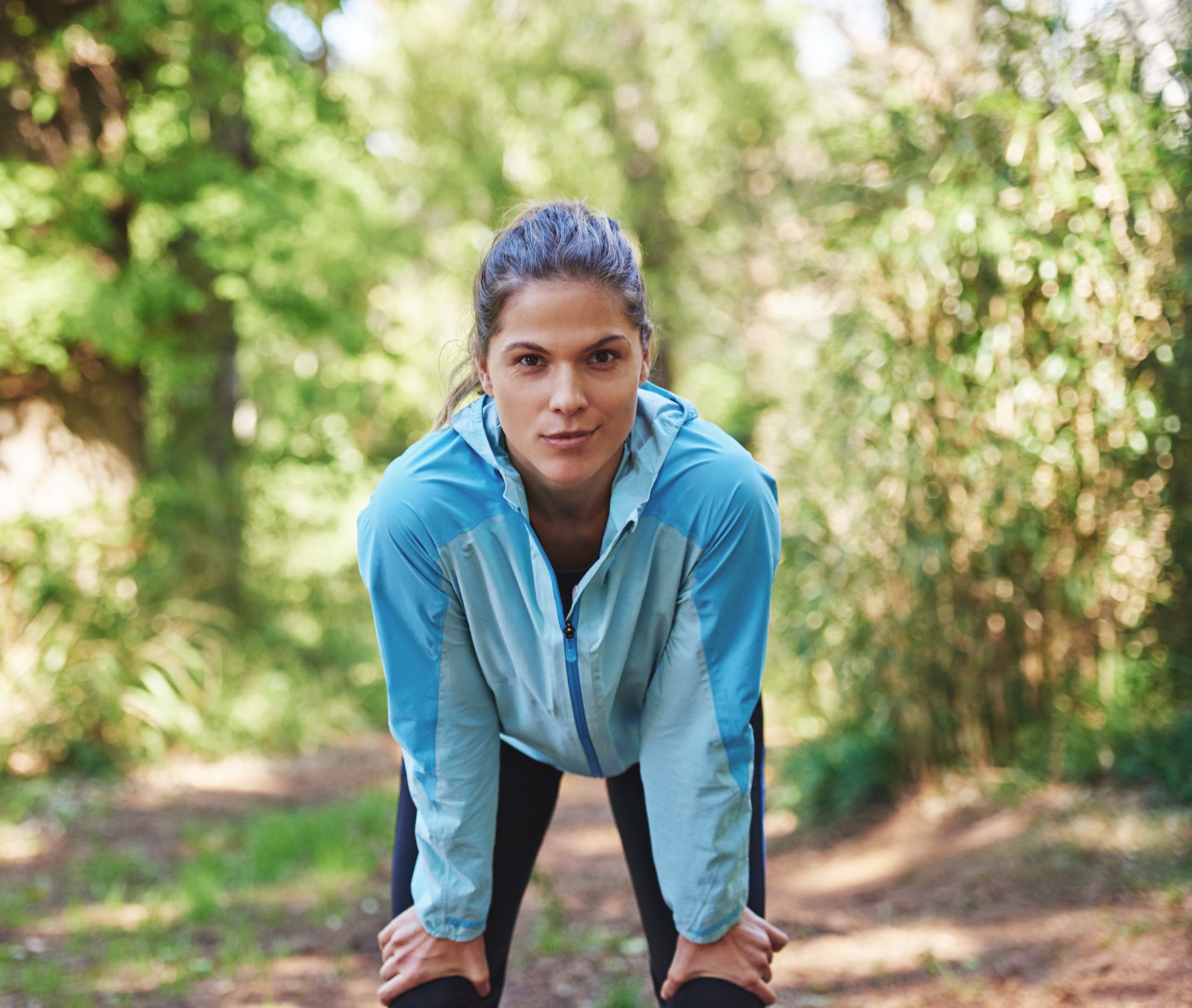 Mujer al aire libre tomando aire después de correr